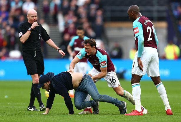 Mark Noble and Angelo Ogbonna fan on pitch