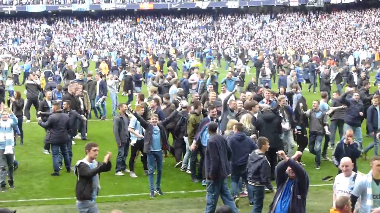 Manchester City fans on pitch