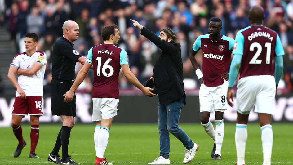 Mark Noble with fan on pitch